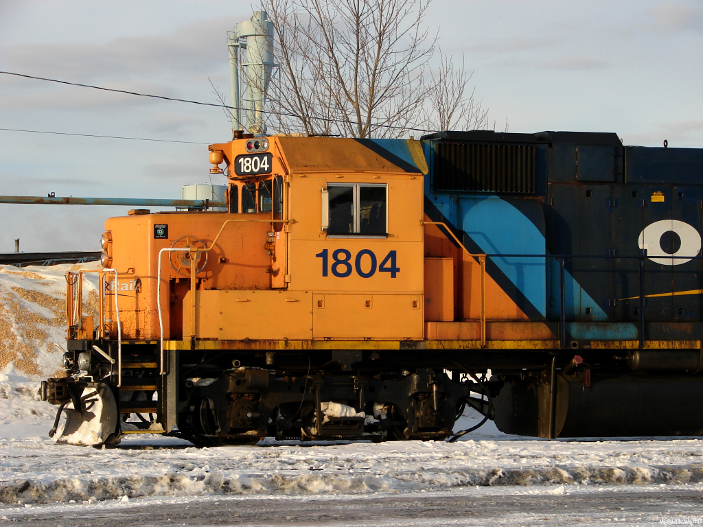 A modern touch on an old classic. Stripped of snow shields and original bell, topped off with a few customized details such as paint work from a wreck that found this GP38-2 on it's side back in August of 2011 (actually just East of here), and the "ONR not for sale!" sticker just underneath the Conductor's window, 1804 and GP40-2 2200 soak up some evening sun in Hearst. This locomotive certainly doesn't owe the ONR anything...