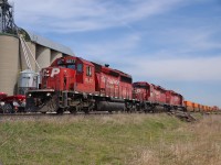 CP 235 heads westbound past the grain elevator at Haycroft led by a trio of SD40-2's