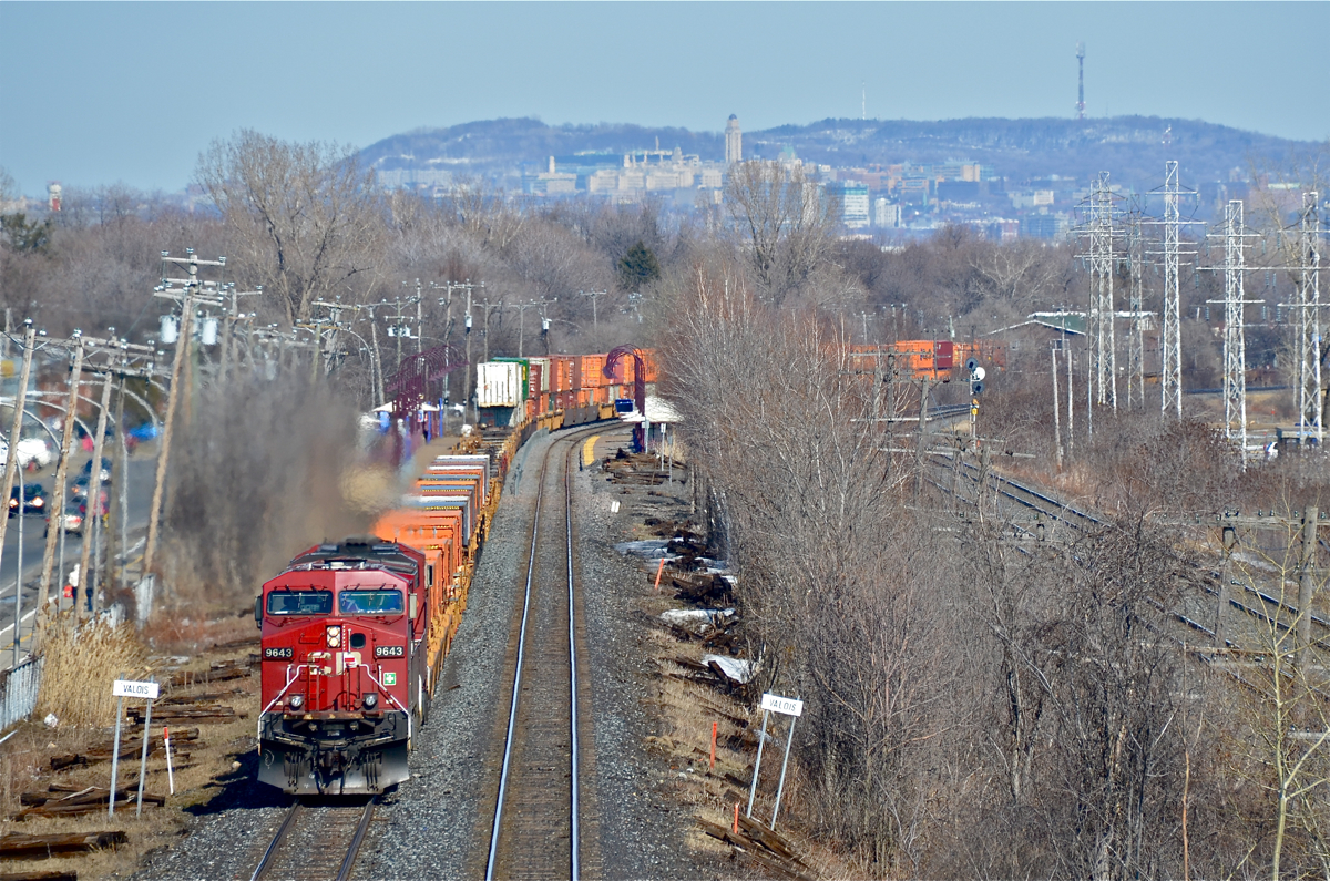 CP 143 curves around a bend on CP's Vaudreuil Sub as the head end passes the advance station sign for Valois Station. Power is a pair of GE's (CP 9643 & CP 8709) For more train photos, click here.