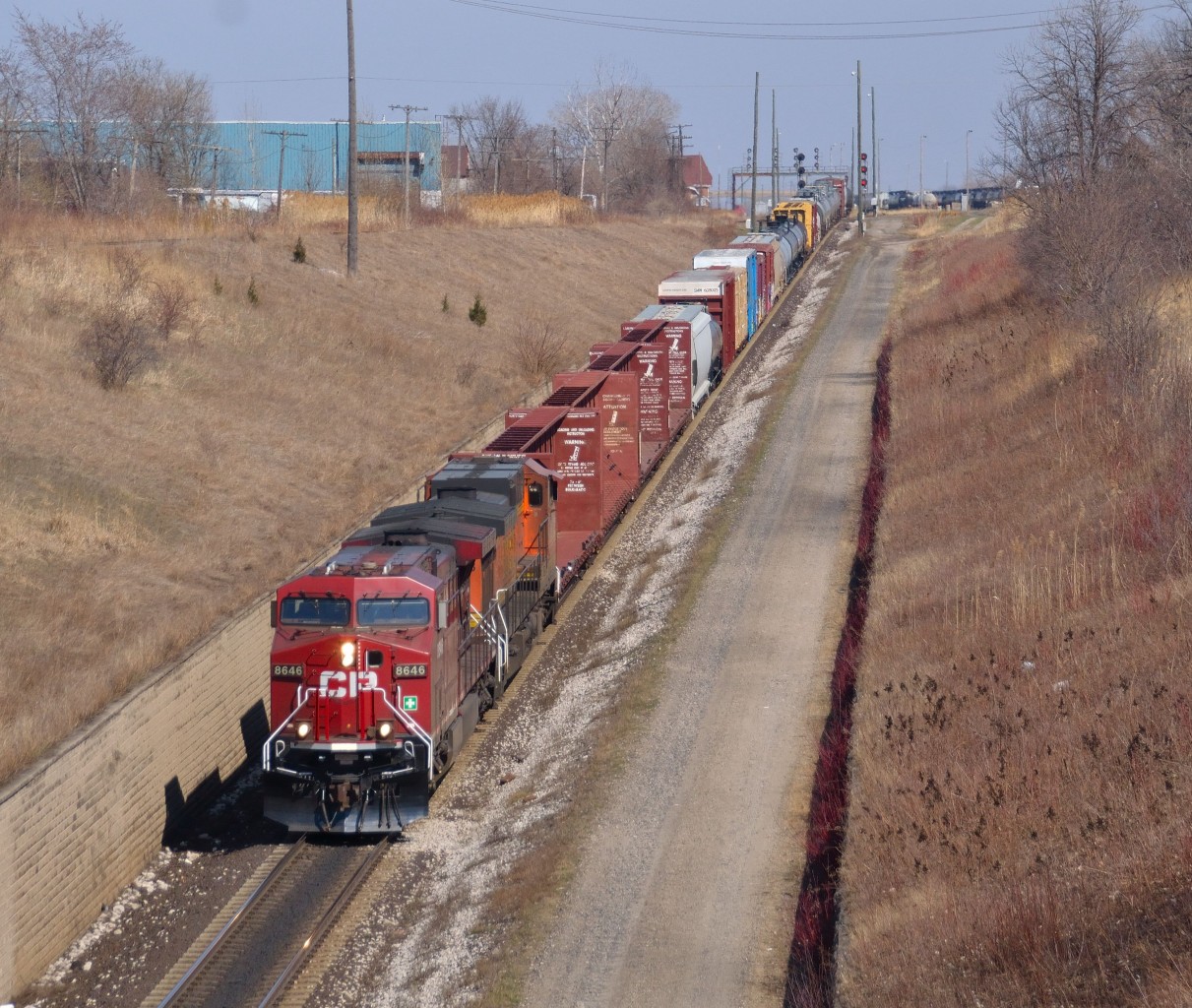 CN 501 makes its decent down the grade towards the tunnel to Port Huron MI led by CP 8646 & BNSF 4723