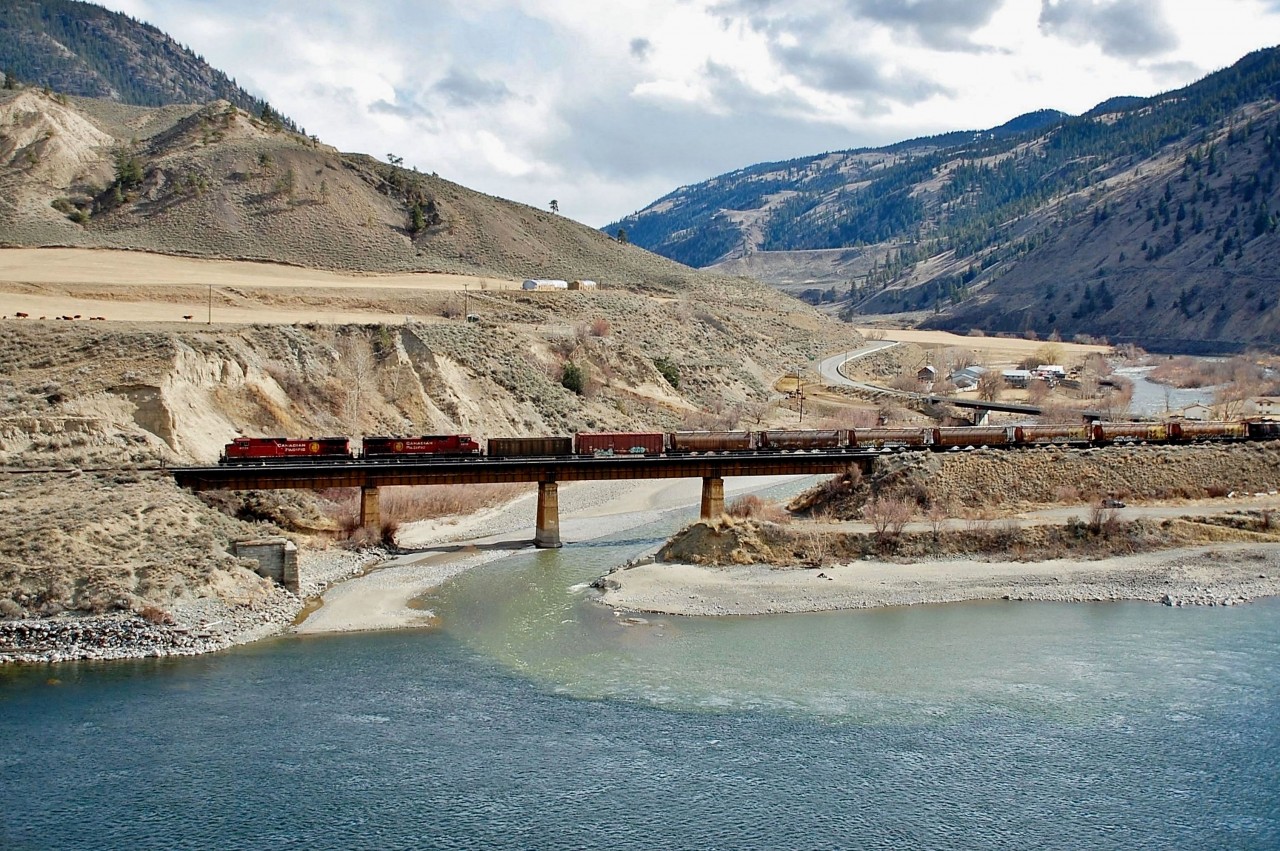 CP nos.9779 & 8613 are in charge of an eastbound mixed freight as they cross the Nicola River just before it merges with the Thompson.