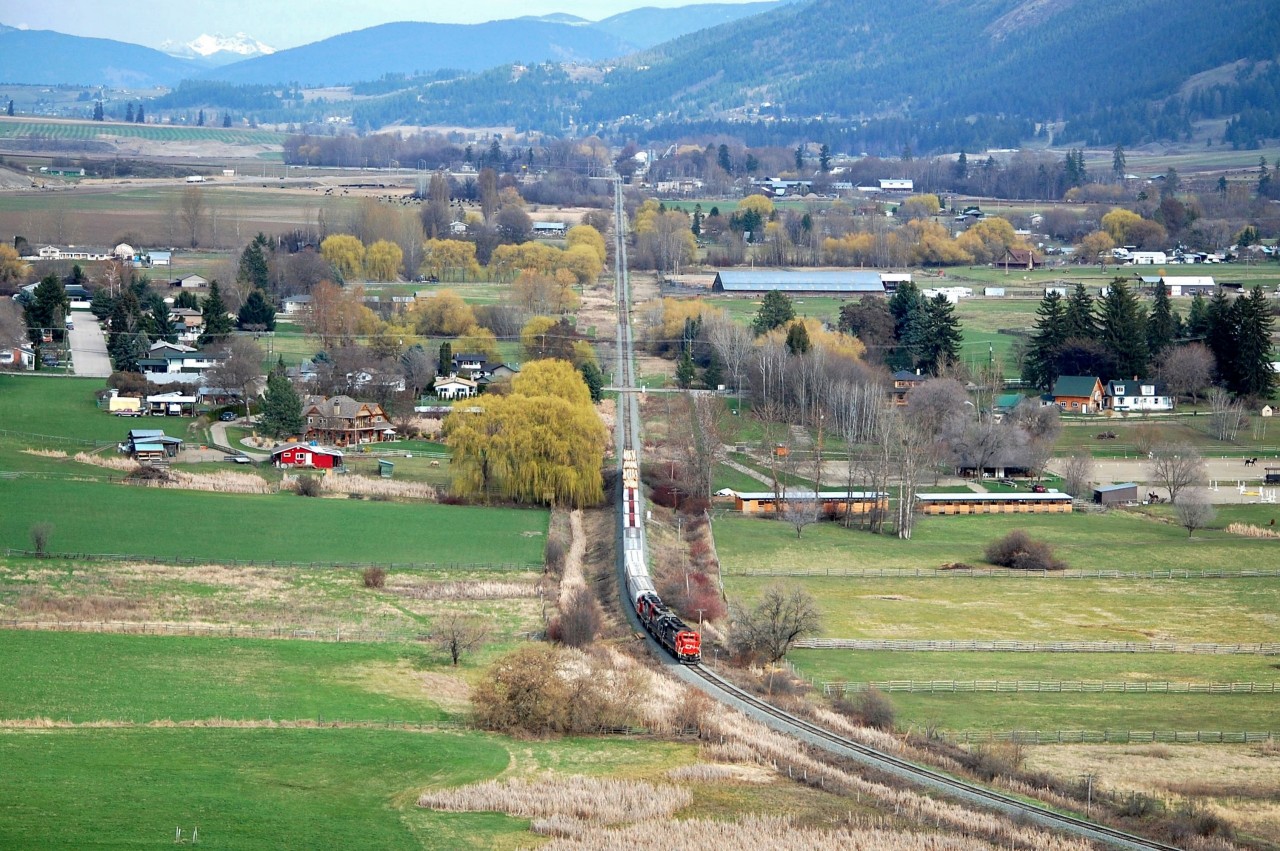 This is a view looking eastwards down the Coldstream Valley with the Monashee mountains in the distance. CN(WC)3027 is the lead unit on this pick-up freight which has recently left Lavington and is approaching Vernon.