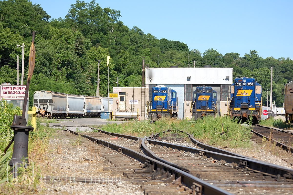 Stuart Street Shops: Beginning of the End. RLK 1756, a GP7u sits in front of the shops, boarded up and having turned her last wheel. RLK 1757, a GP10 (or GP9u, if you prefer)sits with GP18, RLK 1808 awaiting for servicing or return to service on the property. In the coming years, then owner RailAmerica will divulge themselves of this older RLK power scrapping numerous units, including the boarded up 1756 and I believe 1757. The 1808 ended up going to Cando's Barrie-Collingwood operation in Utopia, Ontario.