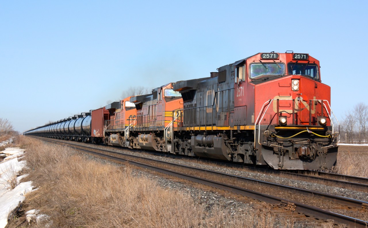 CN 710 oil train heading east bound at Waterworks Road lead by CN2571 with BNSF5528 and BNSF5828.