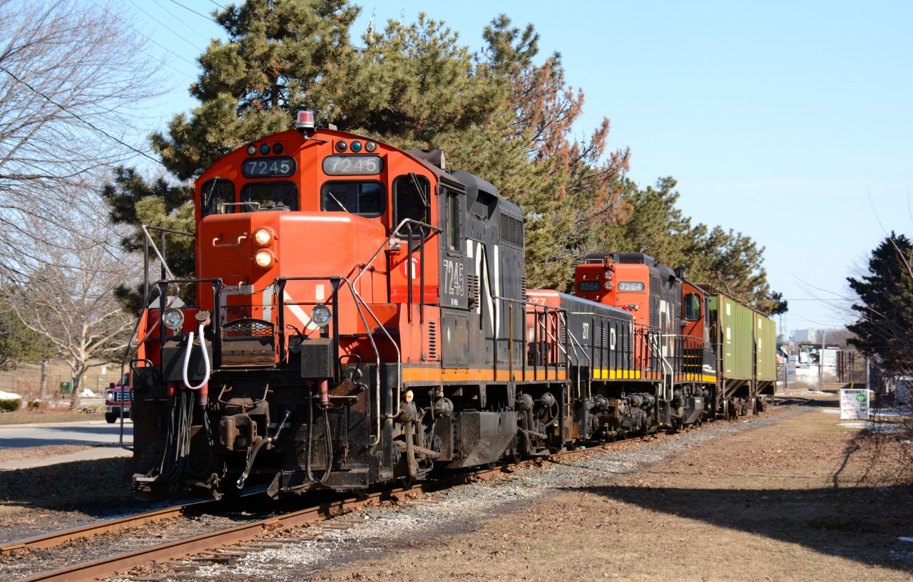 CN7245 with slug 227 and CN7264 working the Cargill elevator shunt at Maxwell Street in Sarnia.