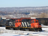 CN GP9RM's 4108 and 7039 back towards their train of "bottles" on a beautiful winter's day in Hamilton. Due to Stelco(?) shutting down their Hamilton facility (which would be temporary), they would move three "hot bottle cars" to Nanticoke along with one of their engines No. 85. The hot bottle cars were heavy and 5 "idler's" were required between them. The move was run between CN and SOR crews. The train would back thru Bayview and head west up the Dundas with these CN units leading to Brantford. More photo's of this unique move will follow.