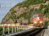 Shear rock cliffs, slide fences, tight curves and bridges are the typical scenes of railroading along the North Shore of Superior and it is all summed up in this photo of CP Winnipeg to Toronto freight 222 as it crosses the Little Pic River. Power was CP AC4400CW 9717- CP SD40-2B 6079- CP AC440CW 9584.