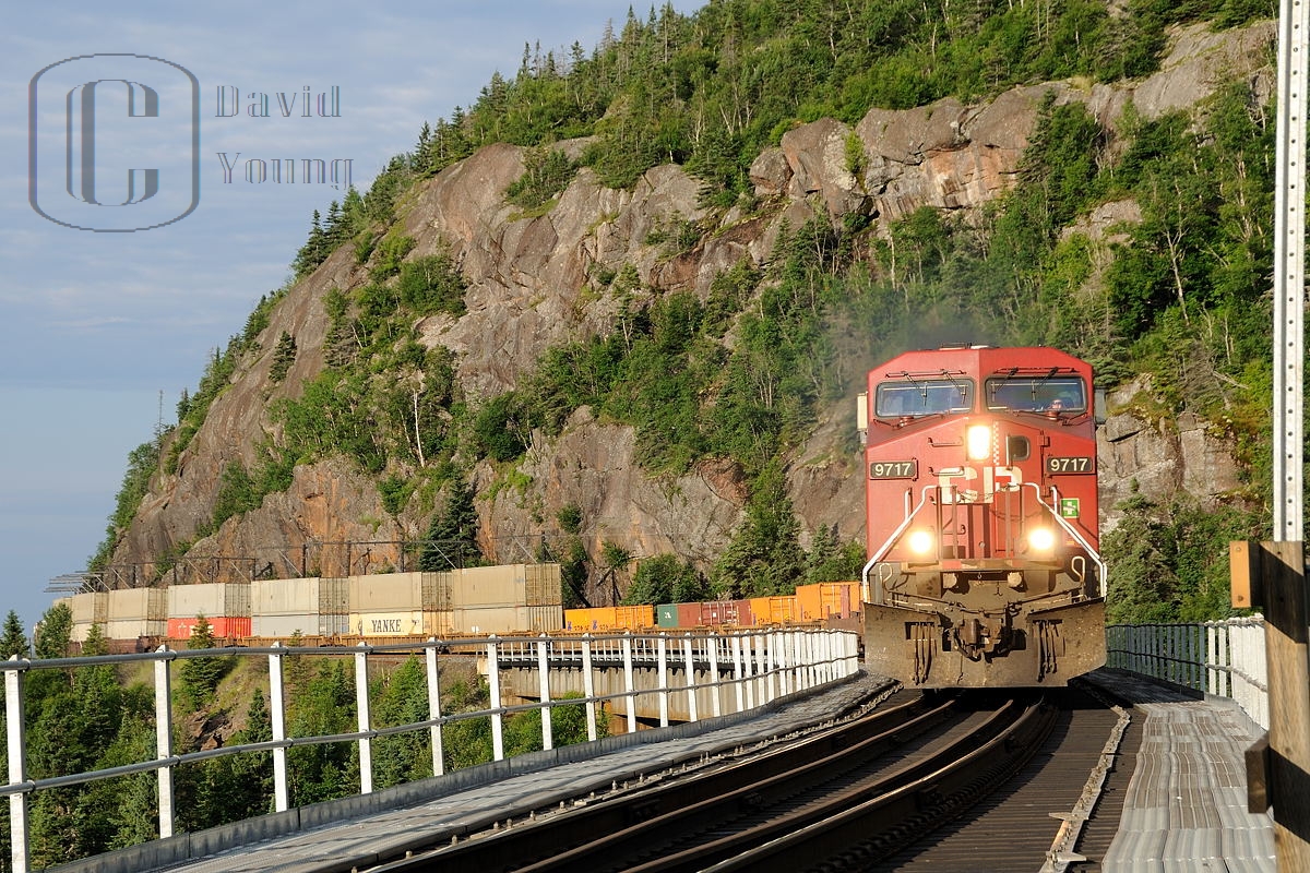 Shear rock cliffs, slide fences, tight curves and bridges are the typical scenes of railroading along the North Shore of Superior and it is all summed up in this photo of CP Winnipeg to Toronto freight 222 as it crosses the Little Pic River. Power was CP AC4400CW 9717- CP SD40-2B 6079- CP AC440CW 9584.