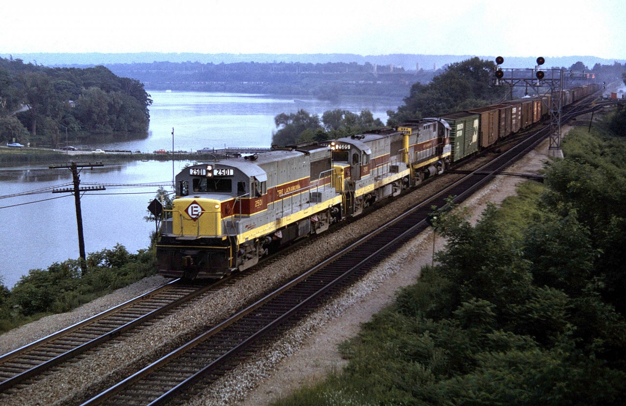 Hurricane Agnes was a very rare storm that came inland and caused major destruction to upper New York State with major flooding. It washed out most of the Erie-Lackawanna which ultimately caused its bankruptcy. Due to the storm E-L rerouted its trains through Southern Ontario most notably over the TH&B and the CNR. Here we see a detouring E-L train lead by a pair of GE U25B's up front (2501 and 2505, with C424 2412 trailing) heading through Bayview Junction, eastbound on CN's Oakville Sub.  Douglas Page photo, Collection of Tony Desantis.