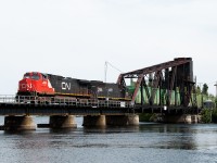 CN train 347 has just departed Ranier Minnesota and crosses the International Bridge over the Rainy River on the east side of Fort Frances. This is the second busiest international rail crossing after Sarnia - Port Huron.