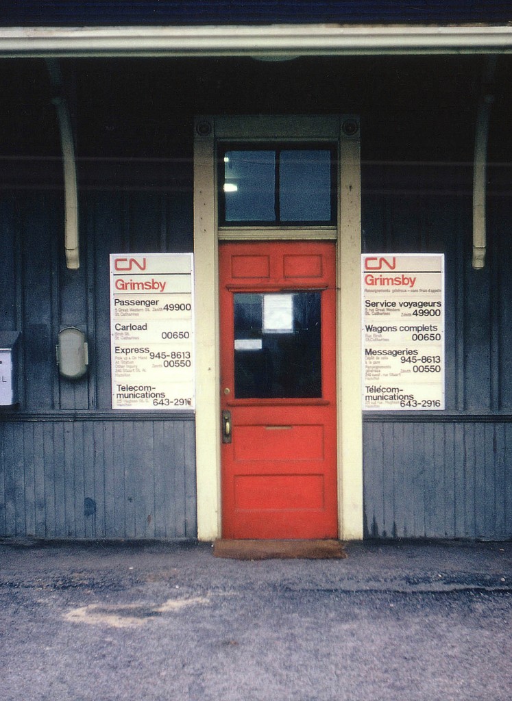 Many years ago this scene could be repeated at almost every CN station across the country. No doubt this will bring back memories for the older fellers on this site. The ivory frame, orangy-red door, grey board/batten appearance of the old wooden structure and those flimsy brittle plastic signs advertising how to connect with the railroad. I wonder where all those signs have gone? The "Zenith" phone number was brought to my attention. Just one of those changes that go unnoticed in everyday life.  To reach "Passenger" as noted on the board, dial "O" for operator and ask for the Zenith number (49900) and the operator would look in her notebook at the switchboard and make the connection for you, thereby relieving either party of any long distance changes. This was the forerunner of the "1-800" system which came into existence around 1967. Grimsby CN station was destroyed by fire on December 31, 1994...........ah!! so THATS where these particular signs have gone.....:o(