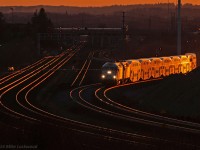 The setting sun illuminates an eastbound GO train as it negotiates the recently opened (within the last week) shoo-fly around the South Blair Road grade separation. The new GO 660 leads 612 on a shakedown run. Shot was taken with my 300mm 'howitzer' hand held and manually focused, a real adventure given that this lens does not have an infinity and my eye won't focus anymore! 2008hrs.