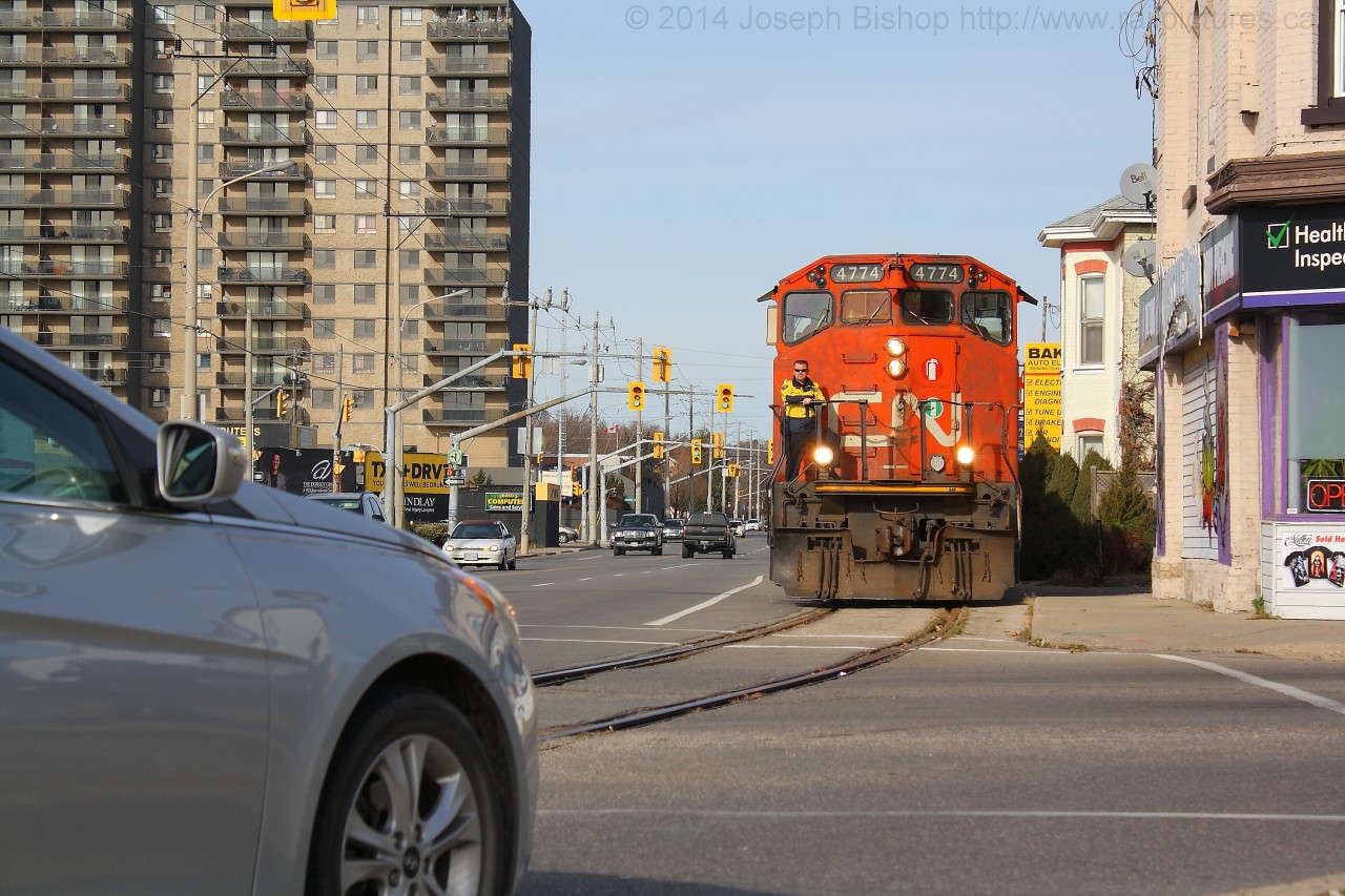 CN 4774 pauses at Colbourne Street to allow motorists to clear out of their way so that they can continue down the Burford Spur.