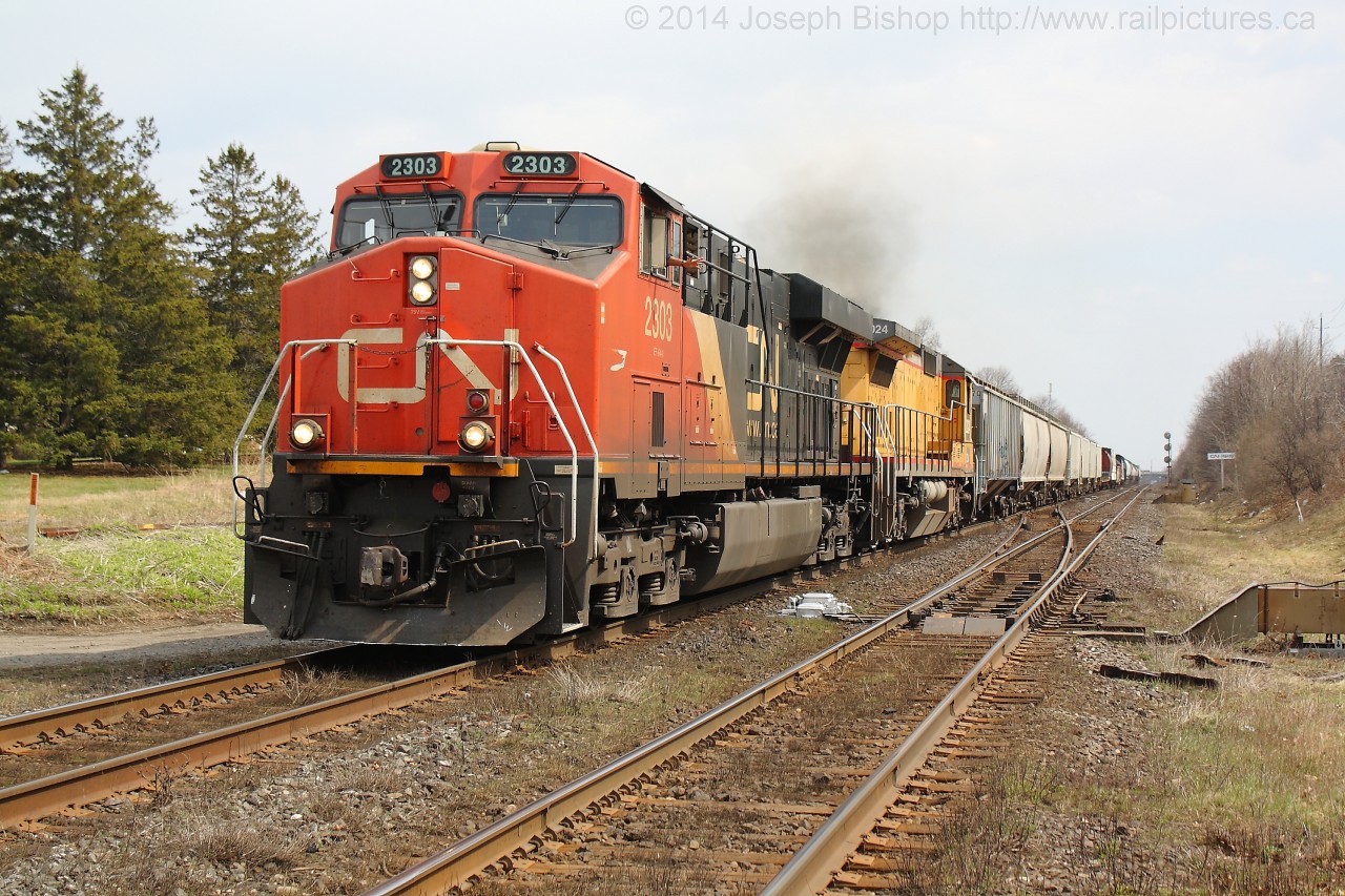 CN 2303 and CN 2024 hustle 435 by Hardy Road with a short train after completing a large set off at Brantford.  I have had good luck with having ex CREX units on 435 in the past few weeks.  435 also set off CN 4721 at Brantford to be used on 580, so if anyone wants to shoot a ratty looking geep on the Burford Spur this is the week to do it!
