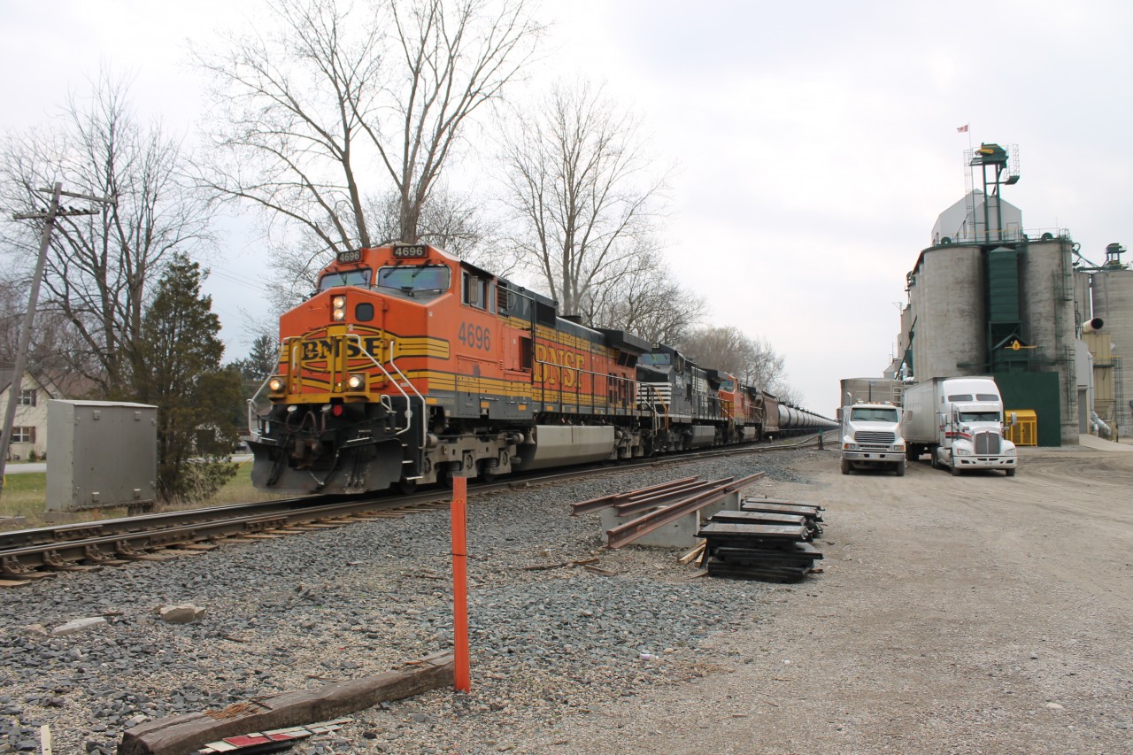 While my dad and I were out for a drive I heard on the scanner a BNSF was leading a train and it had clearance to Tilbury to meet another train (we were in Belle River at the time). While driving to Tilbury we saw the Westbound 608 was suppose to meet. When we got to Tilbury we saw the last tank car going over the crossing and around the curve. So we pulled a quick U-turn (in a drive-way) and jumped on the 401 and raced it to Kent Bridge and we made it with about 5 minutes to spare.