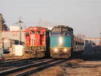 As Via 75 slows down on the approach to the Woodstock Via station, CN M399 slides by on the north track. 