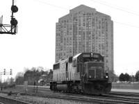 This overcast lighting very appropriately sets the mood for this shot of SOO 6033 as it passes Kipling GO Station. With fire damage to the right side, and a non-working ditchlight, this SD60 is bruised, battered and tired. - See more at: http://www.railpictures.ca/?attachment_id=14617#sthash.KZIe1gqy.dpuf "This overcast lighting very appropriately sets the mood for this shot of this lone SOO SD60 as it passes Kipling station. With fire damage to the right side, and a non-working ditchlight, this SD60 is bruised, battered and tired. Having escaped the rebuild program, it is one of six original SOO SD60's left. How much longer they will last is unknown, but it surely can't be a long time. This particular SOO was probably heading back to Agincourt to get fixed up.