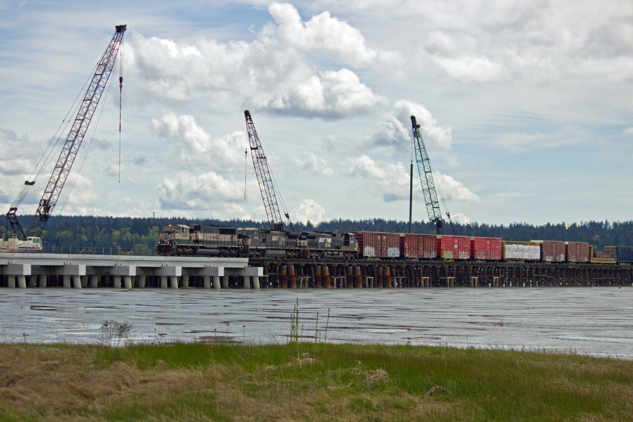 Northbound B.N.S.F. mixed freight on Mud Bay trestle, Surrey, B.C.  Work in progress of major upgrade of trestle from wood to concrete.