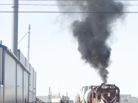 The Guelph Jct. Railway is putting on a nice show as RS18 181 and SW1200 1210 back their train down the spur to the Bi-Pro facility. These tracks are shared with the Goderich-Exeter RR. A track mobile has also just cleared into the facility in the background.