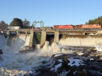 Spring run off! Chunks of ice, and lots of water flow through the dam as CP 246-09 hauls a short freight from Sudbury, ON - CSXT Buffalo Frontier, NY down the directional running zone on the CN Bala Sub