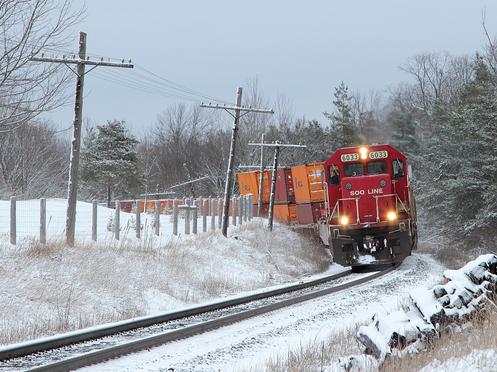 SOO 6033 leads train 235 on the approach to Wolverton, through a "Winter Wonderland" in the middle of April.
