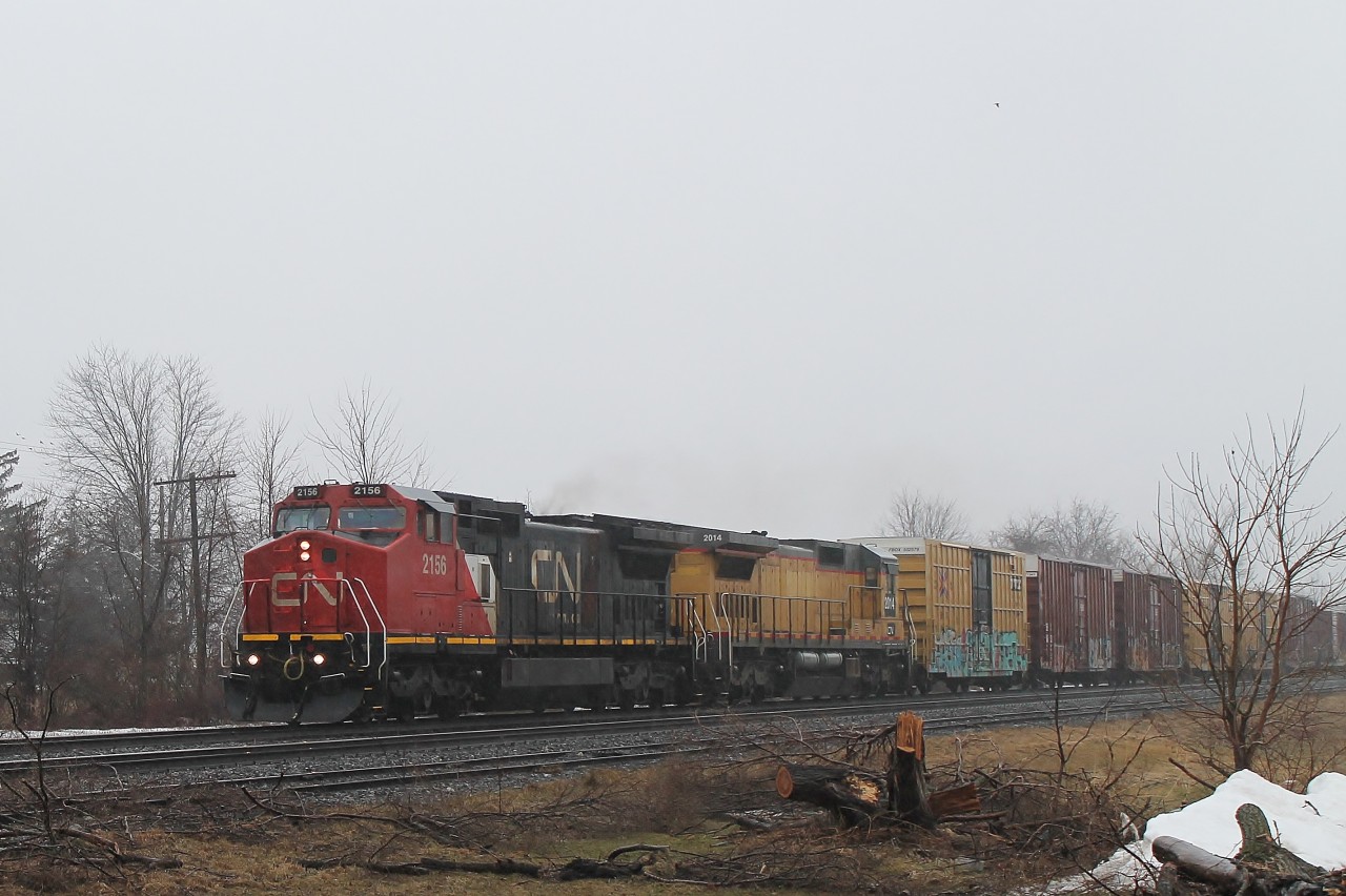 Another Friday and more rain! Still I wont have to shovel! For a change I decided to photograph from the North side of the track as normally the sun makes this difficult. Due to the torrential rain I lifted the tailgate and climbed into the rear of the car much to my dogs amusement to shoot under cover. No sooner had I taken the photo than #331 passed in the other direction! 2156 and 2014 were heading east with mainly box cars.