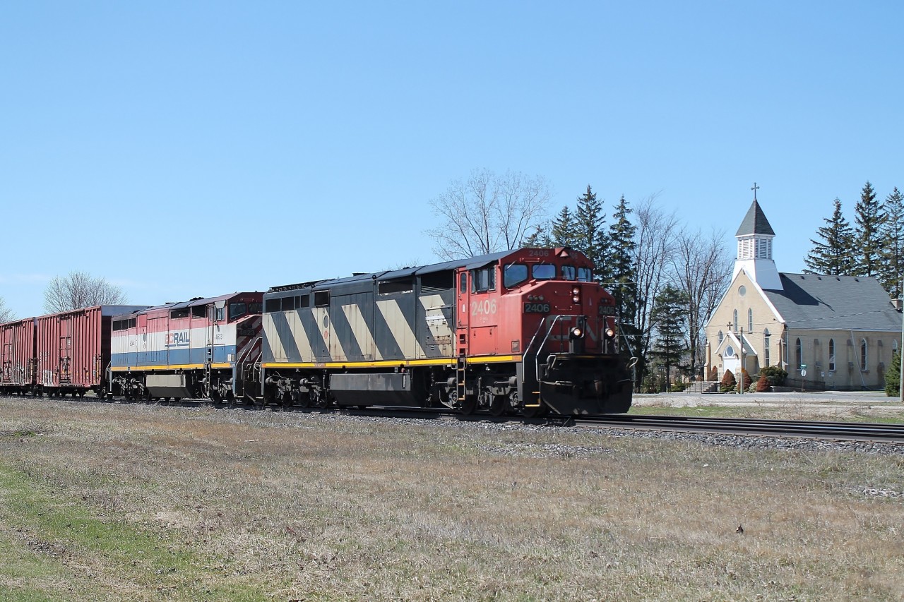 Having spent two hours at the CP line in Drumbo and not seeing anything I moved 8km south to Princeton. I saw the eastbound mixed freight hauled by 2406 and BCOL 4623 passing the striking Sacred Hearts church.