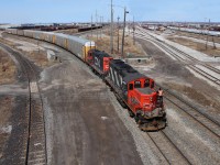 2 Canadian National GP9u's shunt a string of autoracks back and forth in Canadian National's Macmillan yard. For a fun fact, Macmillan yard is the largest of its kind in Canada!