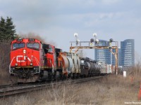 A westbound mixed freight including BCOL 4647 (In CN Paint) rolls by New Westminster underpass. This location will soon not be shootable in the summer as the grass and shrubs to the right will start growing. In the background is the signals on the approach to Snider junction and 2 recently built condo's in North York.