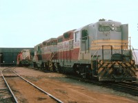 OOPS!!! The was my first time seeing this happening, but in the years since I have seen numerous incidents in which locomotives did a nose-dive into a turntable pit, and am wondering why this was so common. In this example, CP GP9 8531 is nose into the pit, fuel leaking from a rupture, and workmen attempting the rescue first by stacking ties under the truck, while feller GP9s CP 8630 and 8682 are chained to the offending loco to ensure stability. Location not exactly as marked, I have forgotten the location of the roundhouse over the past 40 years. :o)