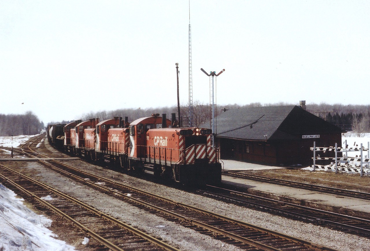 In a most unusual lashup, a quartet of SW1200RS switchers power a mainline freight eastward past the old Guelph Jct station toward Toronto. There was once 72 units in this series, of which 71 were slated to be remanufactured to 1200 series RS1200RSu. Only 33 were done. The CP 8144, 8145, 8164 and 8150 thus renumbered 1239, 1242, 1251 and 1270, between 1981-1984. By 2013 only one locomotive of the series survived on CP, that being 8166. Despite the 'mighty-mites' this train moved along at a good clip, with 84 cars and caboose 434041 in tow.