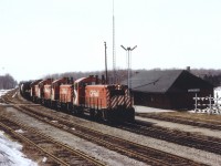 In a most unusual lashup, a quartet of SW1200RS switchers power a mainline freight eastward past the old Guelph Jct station toward Toronto. There was once 72 units in this series, of which 71 were slated to be remanufactured to 1200 series RS1200RSu. Only 33 were done. The CP 8144, 8145, 8164 and 8150 thus renumbered 1239, 1242, 1251 and 1270, between 1981-1984. By 2013 only one locomotive of the series survived on CP, that being 8166. Despite the 'mighty-mites' this train moved along at a good clip, with 84 cars and caboose 434041 in tow.