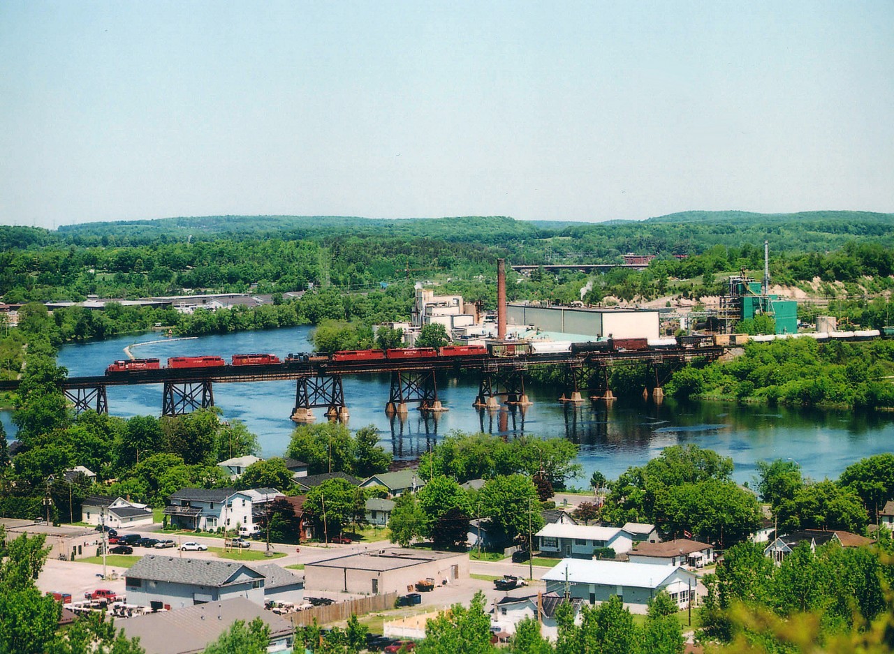 Mayday!!!!  Everything appears normal as westbound CP train #235 with CP 5773, 9014, 5648, 4652, 9001, 9000 and 9018 crosses the Trent River bridge (mile 103) on its way to Toronto from Montreal. But not much later on, 4652 begins to suffer from wheel slip as the train approaches Oshawa. It gets worse, and a motorist passing by sees heavy smoke coming from this unit and calls 9-1-1. At mile 174, East Siding switch, the #1 traction-motor combo (TM & wheel set) overheats, axle breaks, and the train grinds to a halt near Park Rd in Oshawa, trailing 4 units and 27 of the 111 cars derail. Over 1,000 people were evacuated. No lives lost, but it was quite the mess to clean up. Back at Trenton, from my view at Mr. Pilion, the "Ugly sister" 4652 stood out in this consist, despite the fact this train had FOUR 'red barns' up front.