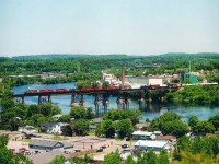 Mayday!!!!  Everything appears normal as westbound CP train #235 with CP 5773, 9014, 5648, 4652, 9001, 9000 and 9018 crosses the Trent River bridge (mile 103) on its way to Toronto from Montreal. But not much later on, 4652 begins to suffer from wheel slip as the train approaches Oshawa. It gets worse, and a motorist passing by sees heavy smoke coming from this unit and calls 9-1-1. At mile 174, East Siding switch, the #1 traction-motor combo (TM & wheel set) overheats, axle breaks, and the train grinds to a halt near Park Rd in Oshawa, trailing 4 units and 27 of the 111 cars derail. Over 1,000 people were evacuated. No lives lost, but it was quite the mess to clean up. Back at Trenton, from my view at Mr. Pilion, the "Ugly sister" 4652 stood out in this consist, despite the fact this train had FOUR 'red barns' up front.