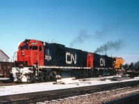 On the heels of Young Mr. Host's image at Paris Jct. is this shot of CN train #401, cutting off his train in order to pick up a piece of heavy machinery on a flatcar which awaited on a Paris Jct spur.  Power is CN 2024 and 2000. Train #401 was popular with the fans, as it backed out of Hamilton to Bayview Jct and awaited a signal in order to proceed west up the Dundas. Memory fails me on the Paris activity. Did the load come down from Goderich where Champion graders were built? The Drumbo Sub was still in place at this time. Anyway, a nice piece of history and comments and any information regarding activity at Paris Jct would be greatly appreciated.