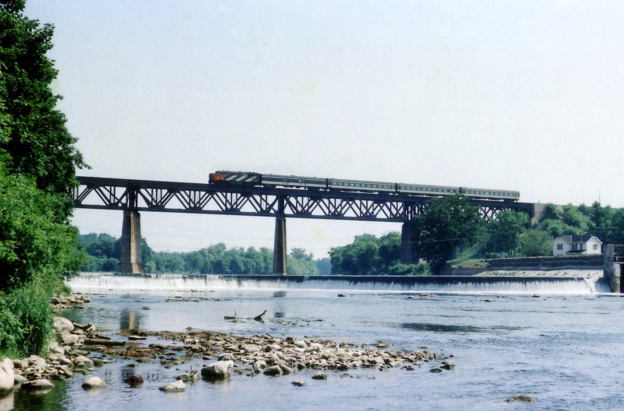 Westbound CN passenger train #81 rolls westward over the Grand River at Paris in this pre-VIA scene on what I recall being a rather sticky & muggy morning . Unable to record the locomotive number.