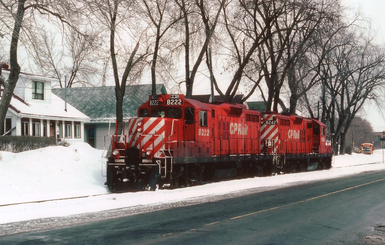CP 8242 is leading 8222 as the power heads back to the main CP line in downtown Niagara Falls after dropping off cars at the industrial area near the old Cyanamid Plant and CN yard. The line runs along the side of Park St for a bit, then cuts right thru the center of the intersection of Bridge St and Victoria Av., making for great auto traffic disruptions. Like almost all other street running in Ontario, however, this scene is a look at the past, as this track and all downtown CP trackage was lifted around fifteen years ago. These days, even the GPs are getting hard to come by.