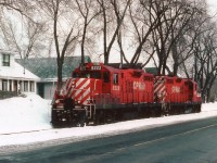 CP 8242 is leading 8222 as the power heads back to the main CP line in downtown Niagara Falls after dropping off cars at the industrial area near the old Cyanamid Plant and CN yard. The line runs along the side of Park St for a bit, then cuts right thru the center of the intersection of Bridge St and Victoria Av., making for great auto traffic disruptions. Like almost all other street running in Ontario, however, this scene is a look at the past, as this track and all downtown CP trackage was lifted around fifteen years ago. These days, even the GPs are getting hard to come by.