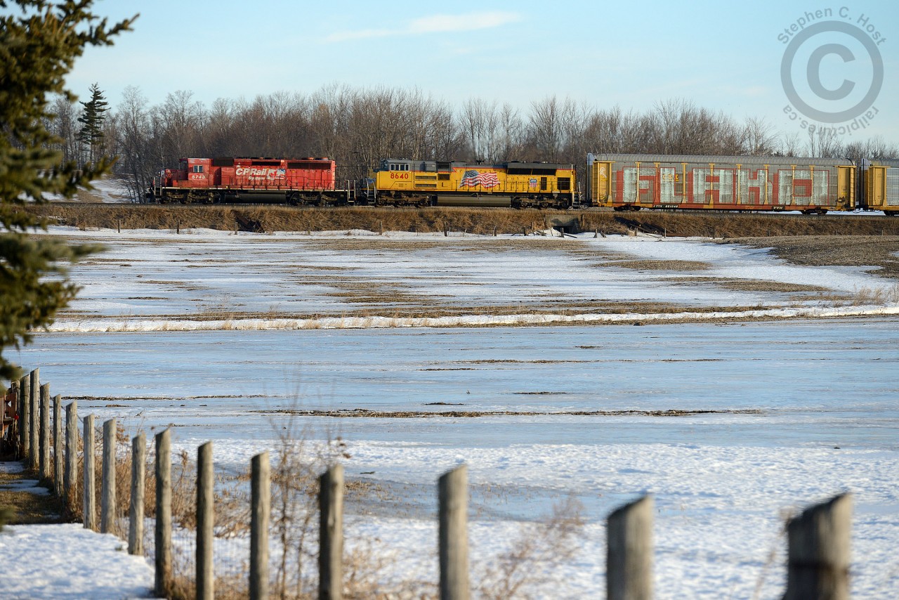 Making the third round trip that week, CP SD40-2 5743 and UP SD70ACe 8640 westward bound with a bunch of autoracks - the sheer size of Graffiti on the first autorack boggles the mind on how these kids get away with it.