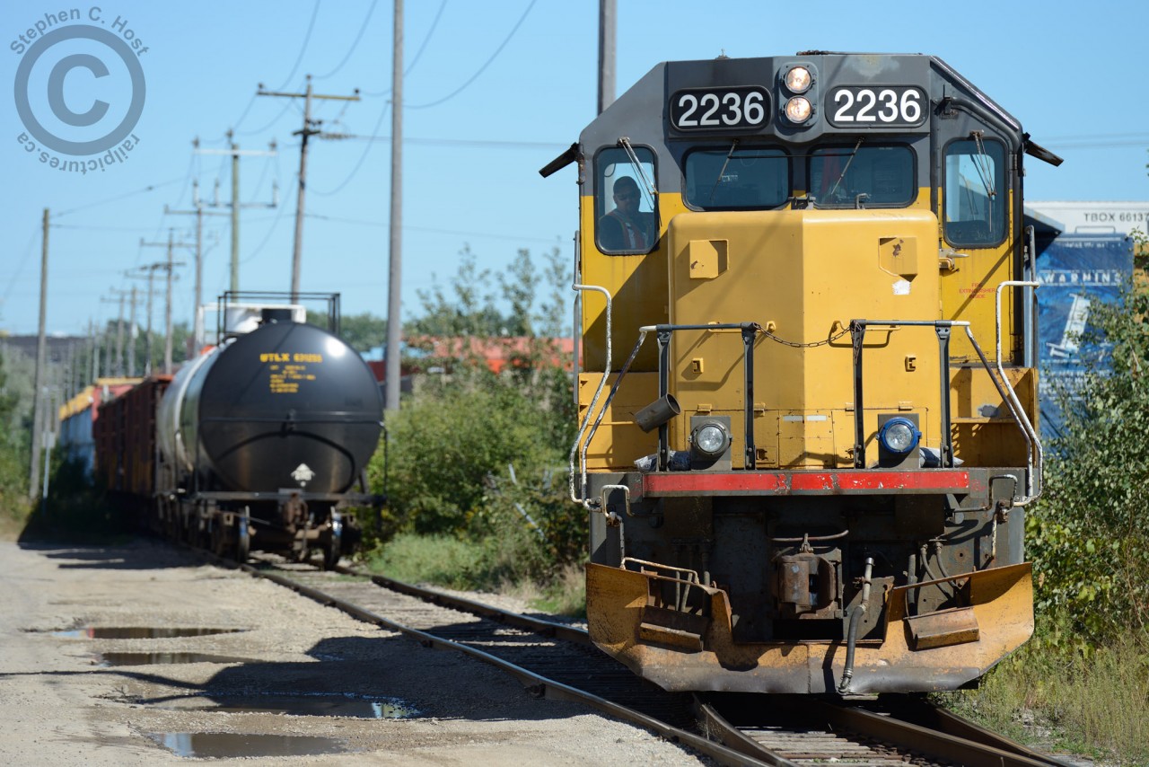 Working the customer - seen here shoving cars into Gillies Lumber on the Galt Industrial Spur built around 1967. With a long train of cars still on the 'main' at rear - after finishing Gillies 582 returns to the former Fergus Subdivision and shoves to Hunt Haulage before returning to Guelph and Kitchener.