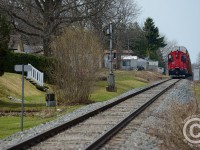 OSR waits at the 1 mile approach signal to Carew Diamond with a pair of SW1200's and 5000 feet of train - CP 242 was handing off 6000' of autoracks to the CP Pender (Toyota) job ahead of OSR on the Galt sub.<br><br>
One has to like the backyards seen here - the railway having been integrated into the landscaping by neighbours.