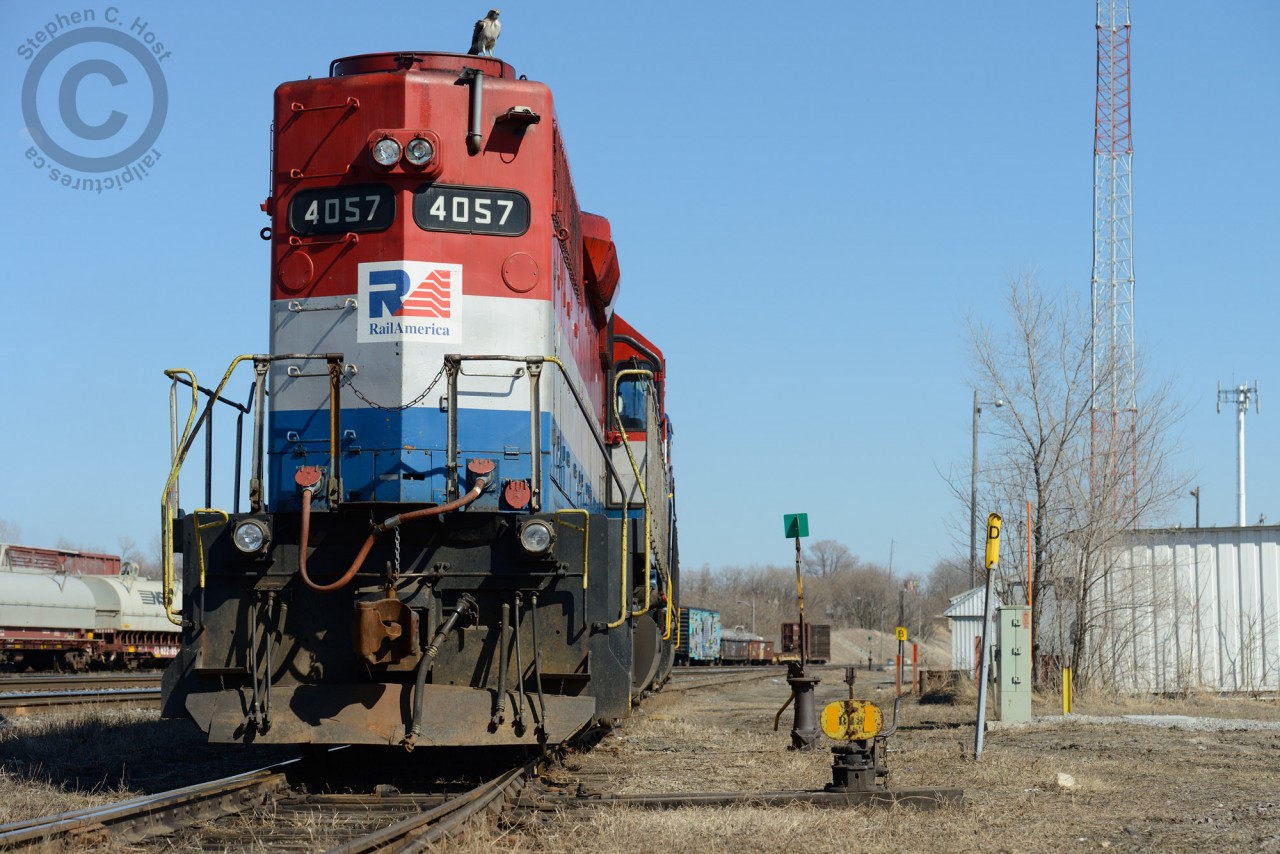 Switch B43 is lined for the reverse for the last time from the former SOR (CN) Shop building at Hamilton -  meanwhile the crew waits about 10 minutes to get the attention of the RTC. Taking advantage of the temporary perch, a bird of prey flew atop RLK 4057 looking for its next meal. After about 4 minutes this bird took off for a kill. Any birders on here that can identify the bird - I can send a full size photo if the bird if need be.

Over the next weeks to months this entire area should be transformed - two new GO mainline tracks are set to be installed where I am standing for the James St. North station - and will look very very different.