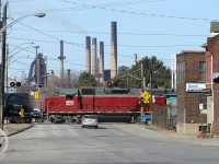 <b>Stelco "E" Blast furnace</b> looms large on Sherman Ave in Hamilton while SOR's 1400 Hamilton Yard job is heading down the N&NW spur with a long cut of about 30 cars. 


