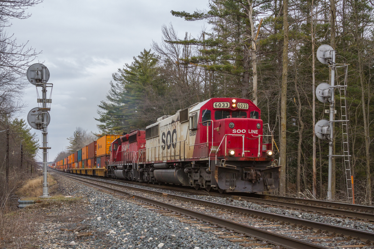 Hockey Stick Nostalgia.Having avoided Canadian Pacific's rebuild program, 1989 built SOO SD60 # 6033 still wears it's original 'Hockey Stick' paint as it hustles a lengthy train of stacks and racks through the west end of Guelph Junction. It is really nice to see a few of these veterans still earning revenue on CP, despite all the changes throughout the last couple of years.