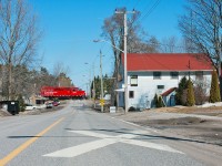 At Mile 148.11 of Canadian Pacific's Havelock Subdivision lies the quiet small town of Burketon, this mornings road switcher from Toronto makes the residences of the town known by blowing for the grade crossing at Old Scugog Road. 