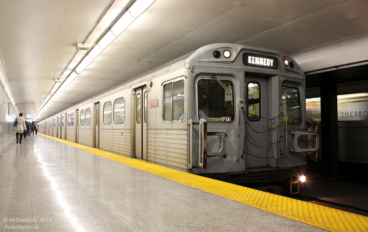 38 years old, orange bench seats, no air conditioning, outdated and being replaced fast, that pretty much summed up the TTC's H4 fleet in their final months. With new Toronto Rocket subway train deliveries moving T1's from the Yonge-University-Spadina to the Bloor-Danforth line, the 1974/75 H4's were on the chopping block first - the last of the original design Hawker Siddeley Canada trains dating from the H1 deliveries in the early 60's.  Rather than nabbing the final train full of foamers, or rolling the dice trying to find one out late in the game, the photographer just elected to catch as many as he could in his lens months before they became scarce. Rush-hours were always good for finding a set or three out, but occasionally one would stay in service on a regular all-day run. This late afternoon finds just that, with 5655 leading an H4 set making the drop at Sherbourne Subway Station on the trip east to Kennedy, as an inbound train passes on the other track. Three months later it was curtains for good: the last one ran late January 2012 on a half-hearted "final run" trip.