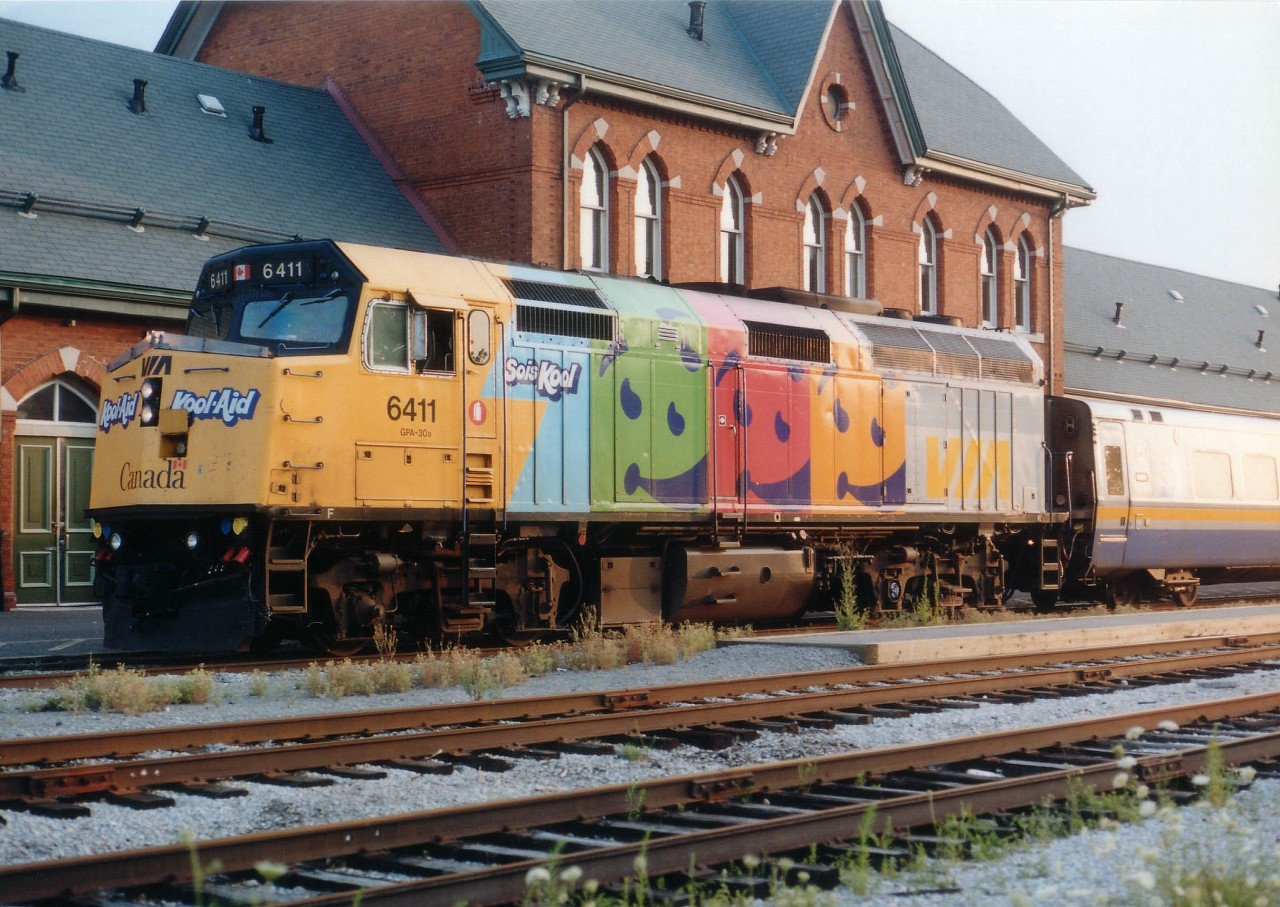 Of all the ad wraps on VIA's locomotives, the Kool Aid graced the most; having covered 10 units. But the promotion was so short-lived in the summer of 2000 that most were gone before fans realized they were in place. Early summer they adorned units 6404,05,06,11,24,32,33,39,53 and 54. By fall they were all gone. This image of KoolAid 6411 out front of the Niagara Falls VIA station was one of only a few I saw. The ad promotion was interesting, colourful, and gave fans something to watch for when the scanners chirped out that another passenger train was on the way. I always wanted to see a wrap featuring "Timmies", with a big donut on the nose. Although we did see Home Hardware, Telus, CBC, Spiderman, Pepsi and Loto Quebec among others over the years, alas.....no Timmies.