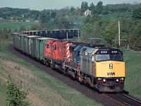 Leased VIA Rail FP40-2 #6438 leading a CP eastbound at Nichols Road, Newtonville, ON (approx MP 150.75, CP Belleville sub) in September 1989.