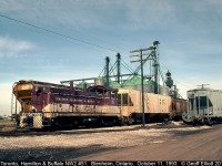 Looking a little worse for wear, TH&B NW2 #51 switches the large W.G. Thompson facility in Blenheim, Ontario back on October 11, 1993.  In the background you can see the also large King Grain facility.  TH&B #51 has since gone and has been replaced by a Greater Winnipeg Water District 44tonner.