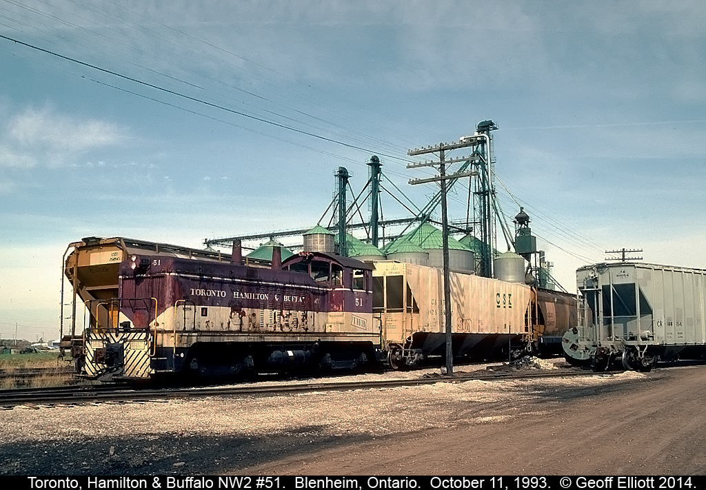 Looking a little worse for wear, TH&B NW2 #51 switches the large W.G. Thompson facility in Blenheim, Ontario back on October 11, 1993.  In the background you can see the also large King Grain facility.  TH&B #51 has since gone and has been replaced by a Greater Winnipeg Water District 44tonner.